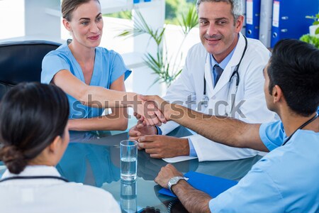 Man smiling and holding a kitten with woman vet Stock photo © wavebreak_media