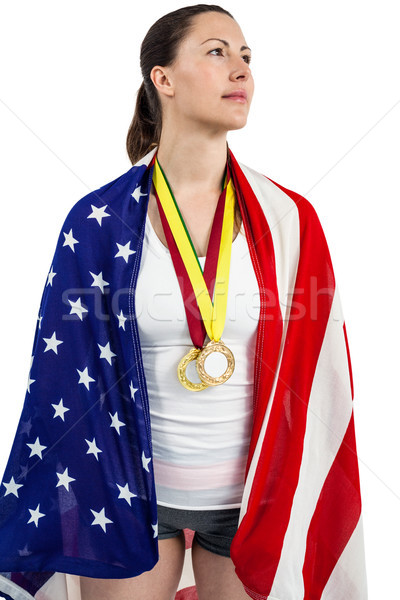 Athlete posing with american flag and gold medals around his nec Stock photo © wavebreak_media