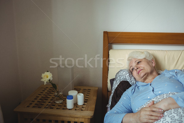 Worried senior woman relaxing on bed Stock photo © wavebreak_media