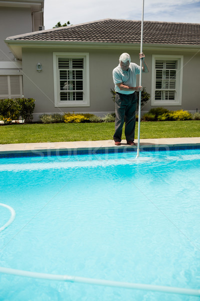 Senior man cleaning swimming pool Stock photo © wavebreak_media
