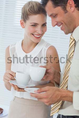 Enamored couple drinking a cup of tea lying on their bed Stock photo © wavebreak_media