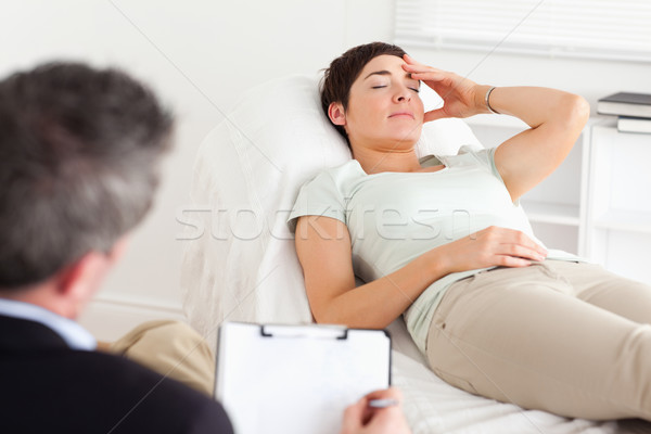 Psychologist talking to a depressed patient in a room Stock photo © wavebreak_media