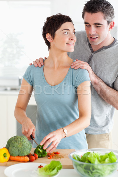 Husband peeking over his wife's shoulder in a kitchen Stock photo © wavebreak_media