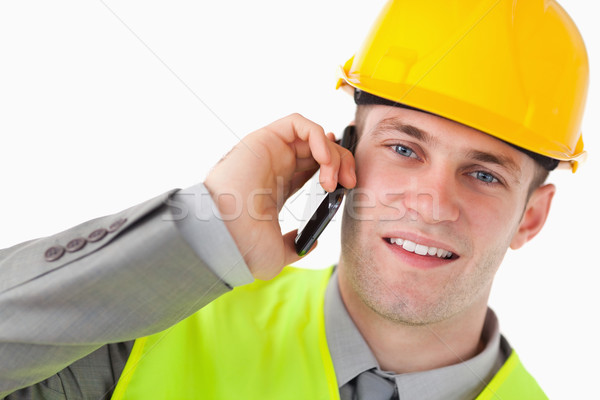 Close up of a young builder making a phone call against a white background Stock photo © wavebreak_media