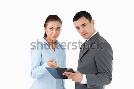 Business partners taking a look at the clipboard against a white background Stock photo © wavebreak_media