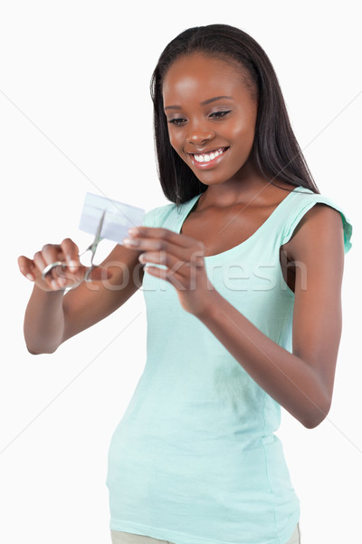 Smiling young woman destroying her credit card against a white background Stock photo © wavebreak_media