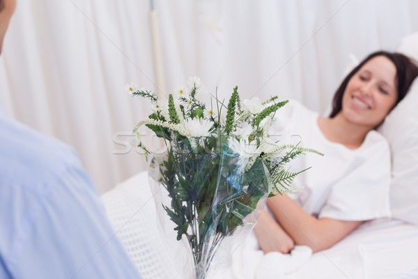 Stock photo: Flowers are brought to female patient
