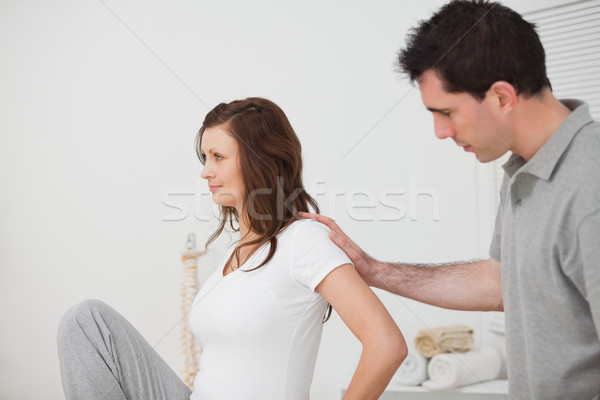 Woman sitting while a man is touching her back in a room Stock photo © wavebreak_media