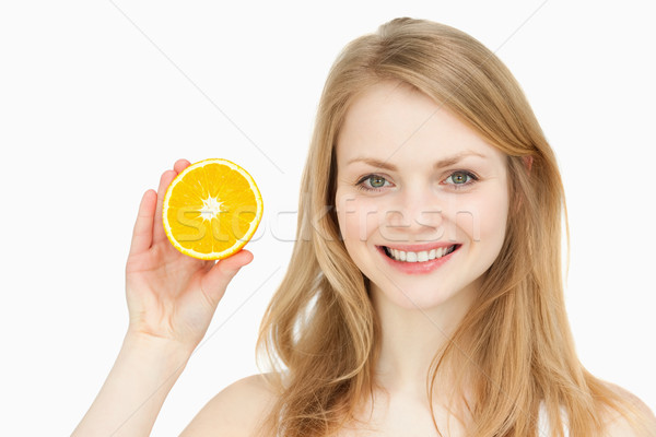 Joyful woman presenting an orange against white background Stock photo © wavebreak_media