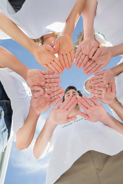 Boldog önkéntesek kezek együtt kék ég alulról fotózva Stock fotó © wavebreak_media