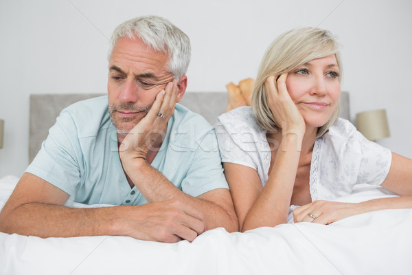 Closeup of displeased mature couple lying in bed Stock photo © wavebreak_media