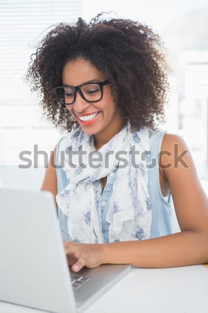 Pretty designer smiling at camera offering her hand Stock photo © wavebreak_media