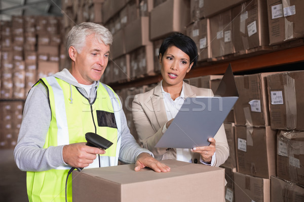 Warehouse worker scanning box with manager Stock photo © wavebreak_media