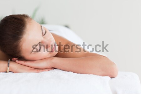 Beautiful woman lying on massage table at spa center Stock photo © wavebreak_media