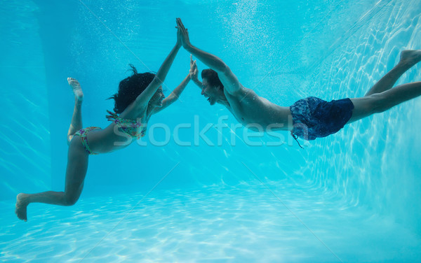 Couple holding hands and swimming underwater Stock photo © wavebreak_media