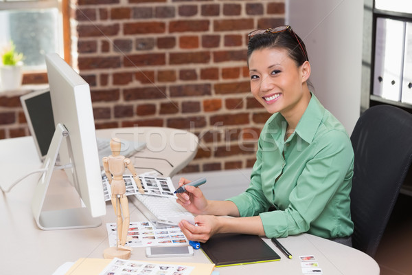 Smiling female photo editor using computer in office Stock photo © wavebreak_media