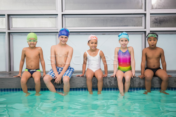 Cute swimming class smiling at camera Stock photo © wavebreak_media