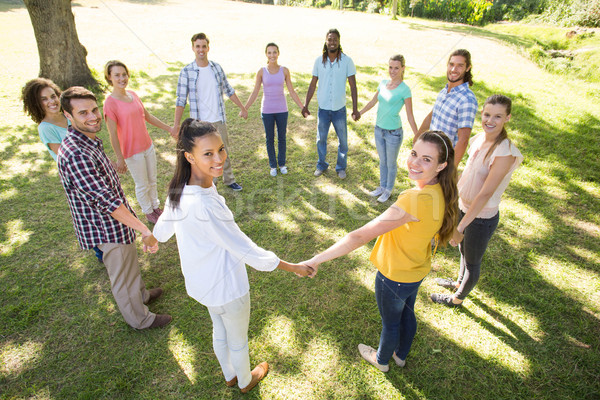 Stock photo: Happy friends in the park holding hands