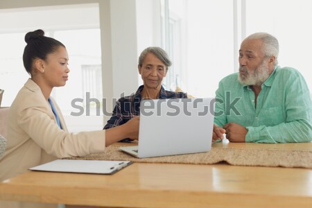 équipe commerciale travail heureusement ensemble portable bureau [[stock_photo]] © wavebreak_media