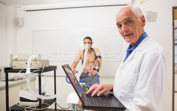 Doctor conducting fitness test smiling at camera Stock photo © wavebreak_media