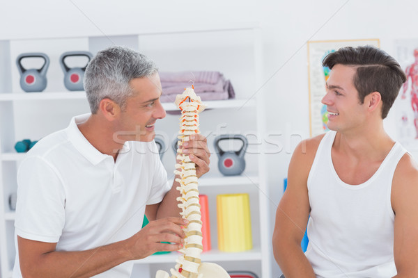 Doctor showing anatomical spine to his patient  Stock photo © wavebreak_media