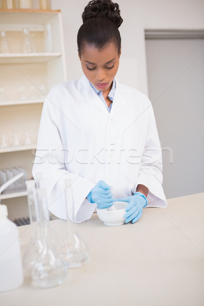 Concentrated scientist using pestle and mortar Stock photo © wavebreak_media