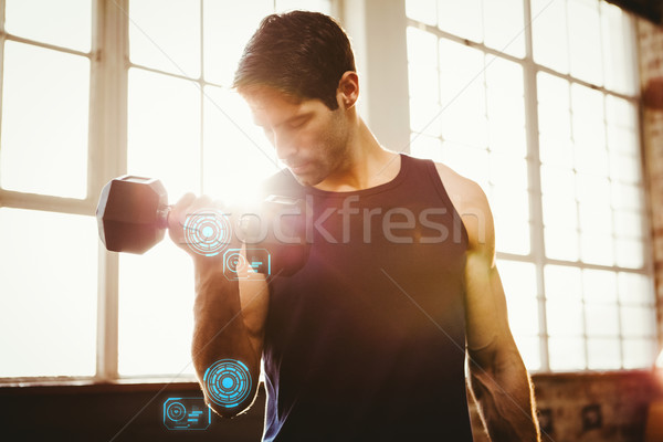 Composite image of handsome man lifting dumbbell Stock photo © wavebreak_media
