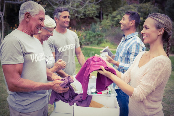 Happy volunteer family separating donations stuffs Stock photo © wavebreak_media