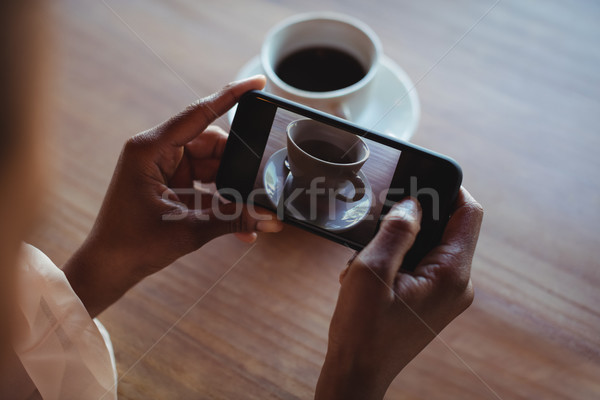 Stock photo: Hands of woman taking a clicking picture of black coffee