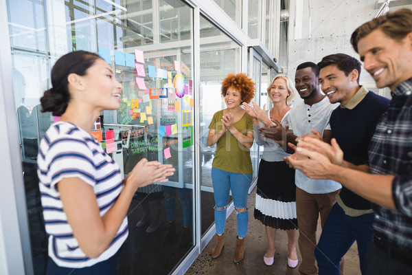 Heureux gens d'affaires permanent plan verre [[stock_photo]] © wavebreak_media