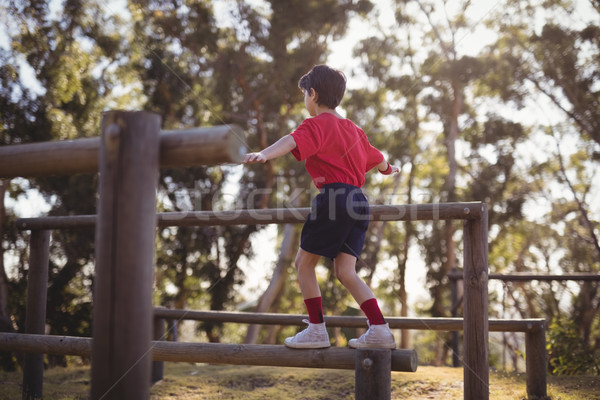 Boy walking on obstacle during obstacle course Stock photo © wavebreak_media
