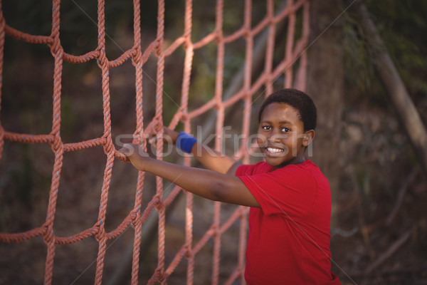 Portrait of happy boy standing near net during obstacle course Stock photo © wavebreak_media