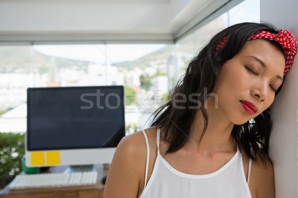 Tensed businesswoman with eyes closed at office Stock photo © wavebreak_media