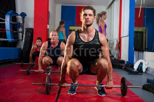Young athletes crouching with barbells Stock photo © wavebreak_media