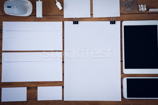 Directly above shot of envelopes with technologies and office supply on wooden table Stock photo © wavebreak_media