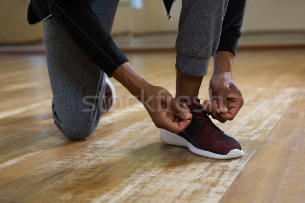 Low section of dancer tying shoelace on floor Stock photo © wavebreak_media