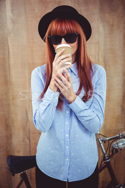 Smiling hipster woman drinking coffee Stock photo © wavebreak_media