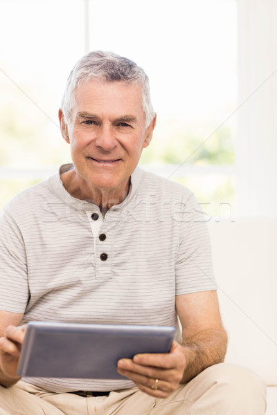 Smiling senior man using tablet Stock photo © wavebreak_media