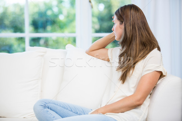 Deprimido mujer sesión sofá argumento socio Foto stock © wavebreak_media