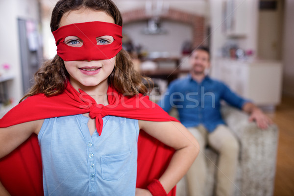 Daughter pretending to be a superhero while father sitting on so Stock photo © wavebreak_media