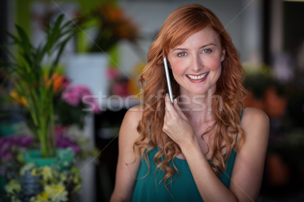 Female florist talking on mobile phone in flower shop Stock photo © wavebreak_media