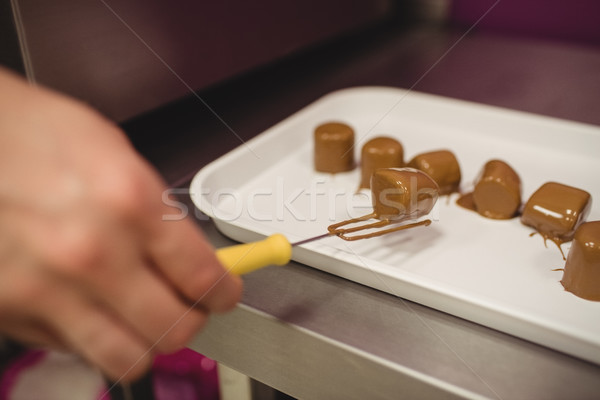 Worker arranging chocolate coated marshmallows on tray Stock photo © wavebreak_media