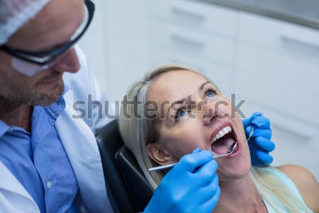 Female surgeon helping her co-worker in wearing surgical cap Stock photo © wavebreak_media