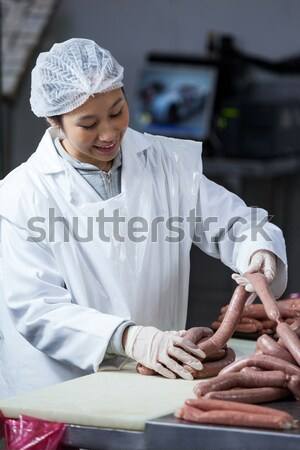 Female butcher cutting raw meat on a band saw machine Stock photo © wavebreak_media