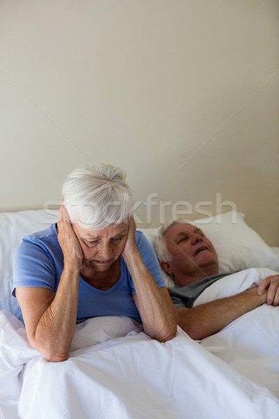Senior woman getting disturbed with man snoring on bed Stock photo © wavebreak_media