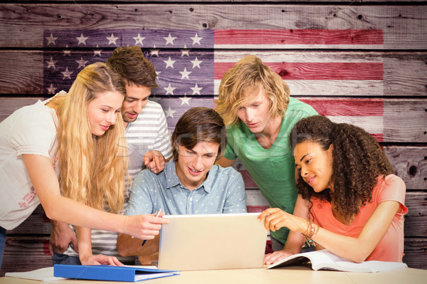 Composite image of college students using laptop in library Stock photo © wavebreak_media