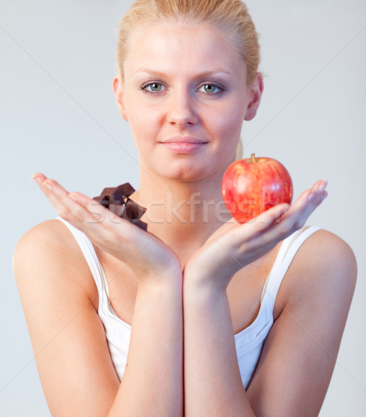 Beautiful woman holding chocolate and apple focus on woman  Stock photo © wavebreak_media