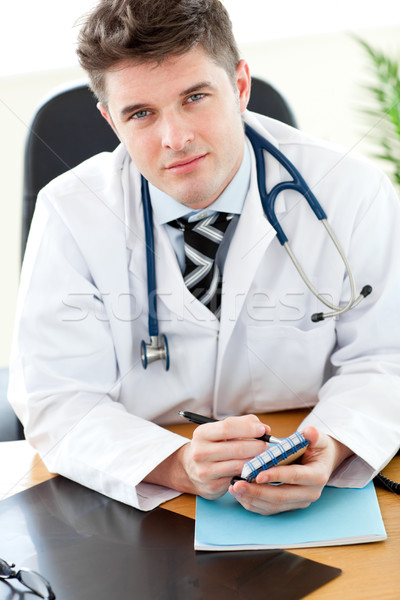 Retrato carismático médico do sexo masculino escrita notas médico Foto stock © wavebreak_media