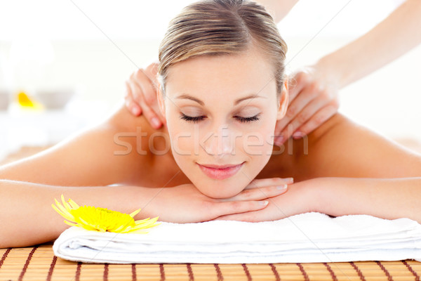 Stock photo: Portrait of a delighted woman lying on a massage table in a health spa