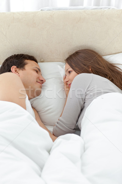 Cute couple looking at each other while relaxing on the bed at home Stock photo © wavebreak_media